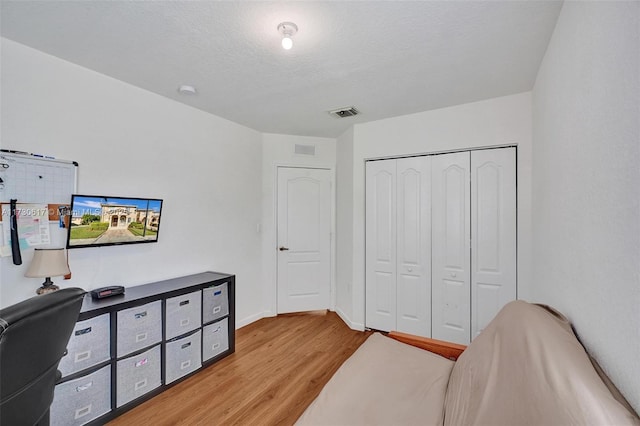 office space featuring light hardwood / wood-style floors and a textured ceiling