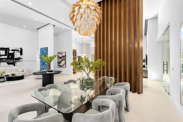 dining space featuring a high ceiling and a notable chandelier