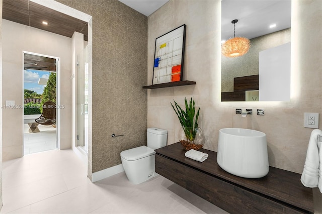 bathroom with toilet, tile walls, a shower with shower door, and tile patterned flooring