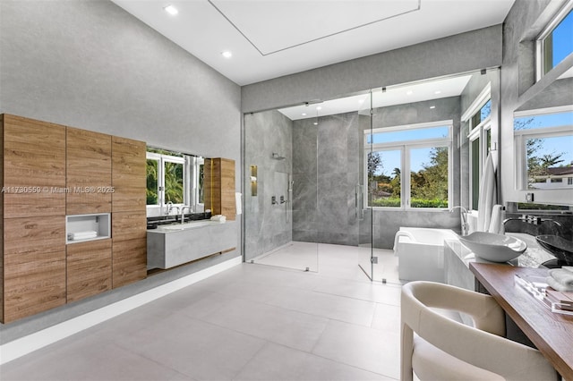 bathroom featuring vanity and independent shower and bath