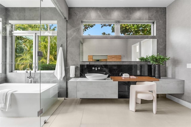 bathroom featuring tile patterned floors, vanity, and a bathing tub