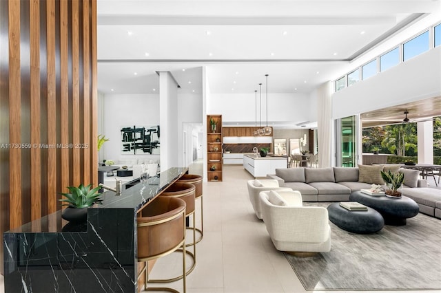 tiled living room featuring a high ceiling