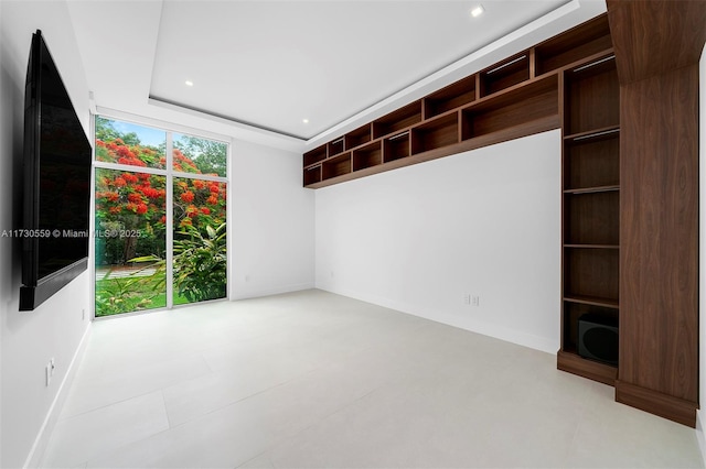 interior space featuring floor to ceiling windows and a tray ceiling