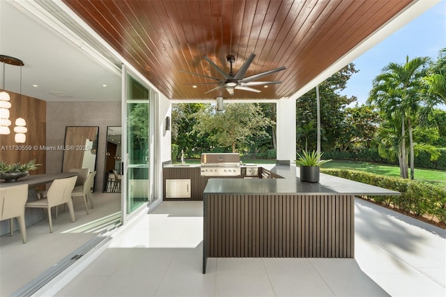 view of patio / terrace featuring ceiling fan, exterior kitchen, and grilling area