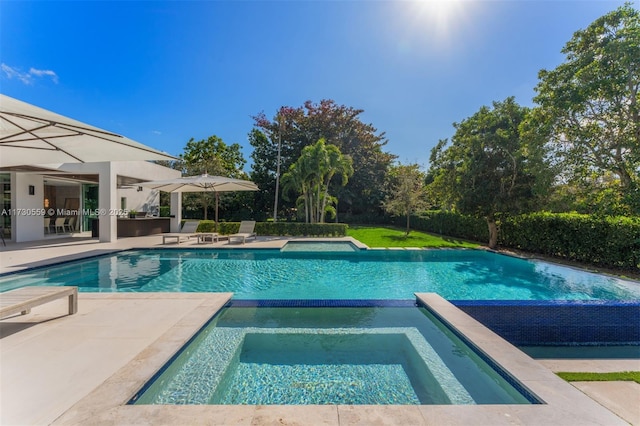 view of pool featuring an in ground hot tub and a patio