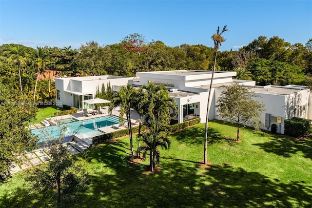 rear view of property with a patio area and a yard