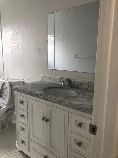 bathroom featuring toilet and vanity