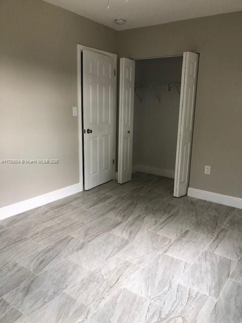 unfurnished bedroom with a closet