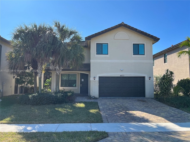 front of property featuring a garage and a front lawn