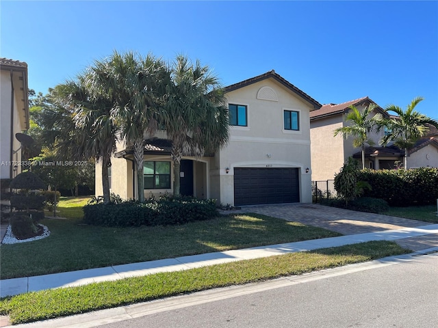 view of front of home with a front yard and a garage