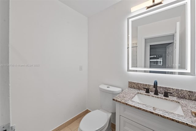 bathroom featuring vanity, toilet, and tile patterned flooring