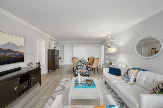 living room featuring crown molding and light wood-type flooring