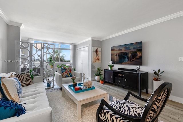 living room with ornamental molding, floor to ceiling windows, and light hardwood / wood-style flooring