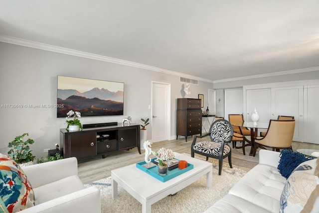 living room featuring crown molding and light hardwood / wood-style floors