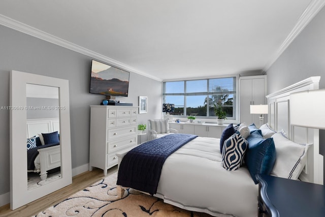 bedroom featuring ornamental molding and light wood-type flooring