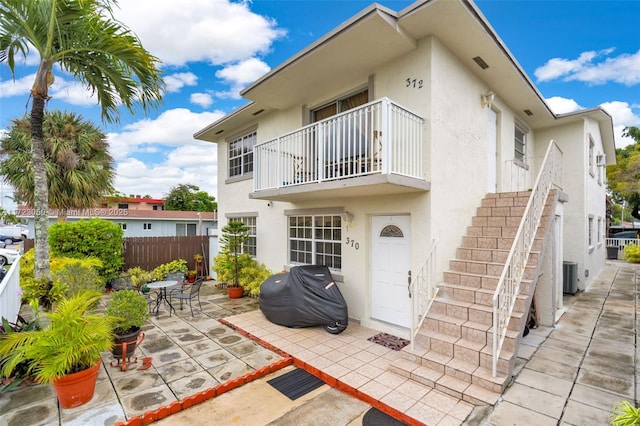 back of property with a patio area and a balcony