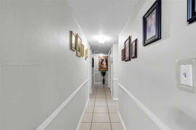 hall with light tile patterned floors