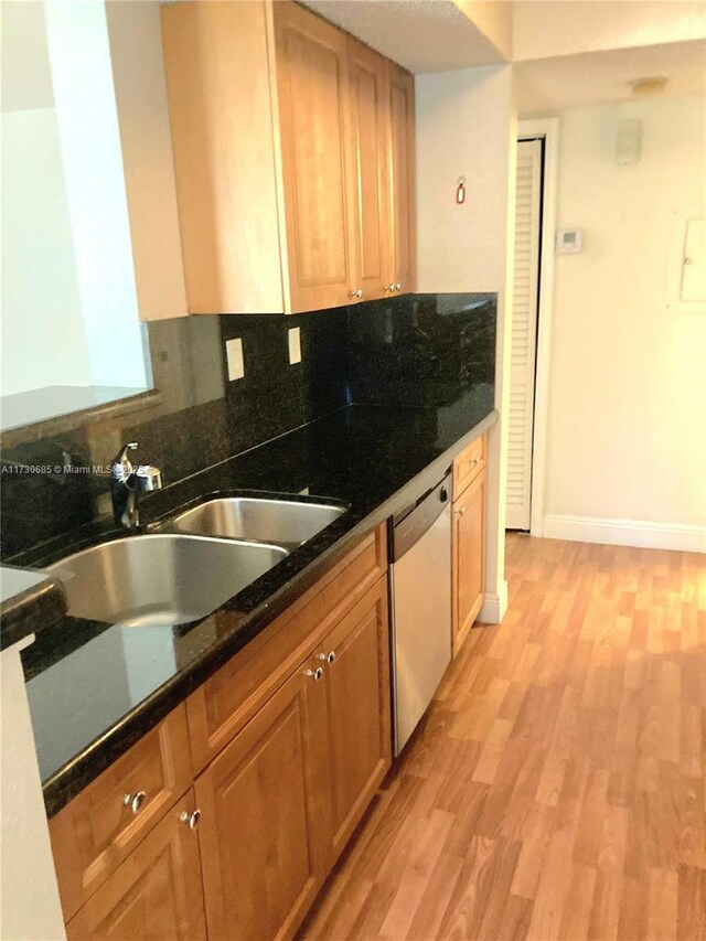 kitchen featuring black refrigerator, sink, electric range oven, and light hardwood / wood-style floors