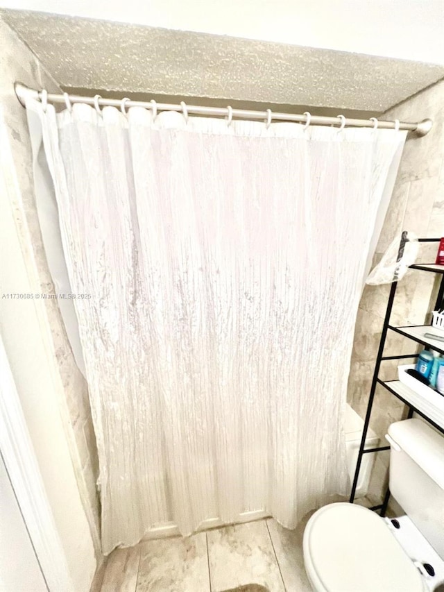 bathroom featuring tile patterned floors and toilet