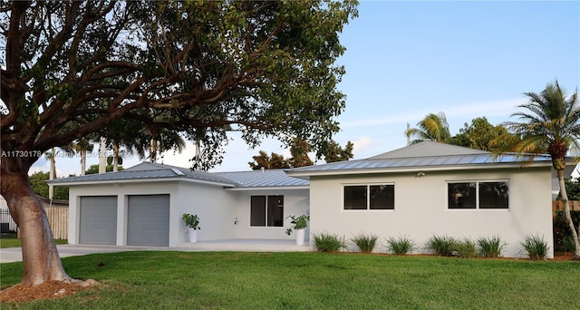 ranch-style house with a garage and a front lawn