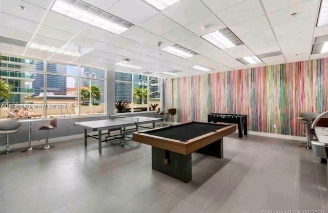 playroom with baseboards, a drop ceiling, and wallpapered walls