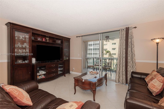 tiled living room featuring floor to ceiling windows and a textured ceiling