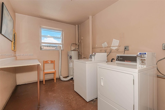 laundry area featuring water heater and washing machine and clothes dryer