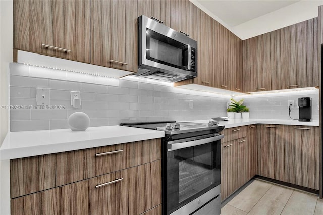 kitchen featuring appliances with stainless steel finishes and decorative backsplash