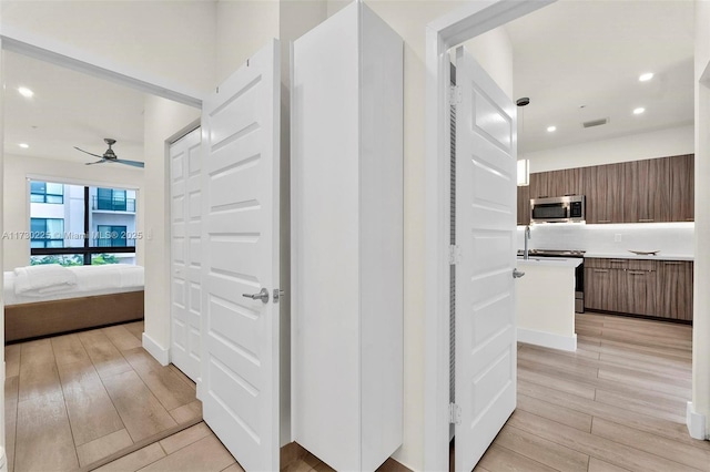 hall with light hardwood / wood-style flooring