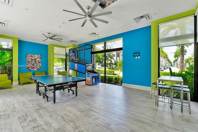 playroom with ceiling fan and light hardwood / wood-style floors