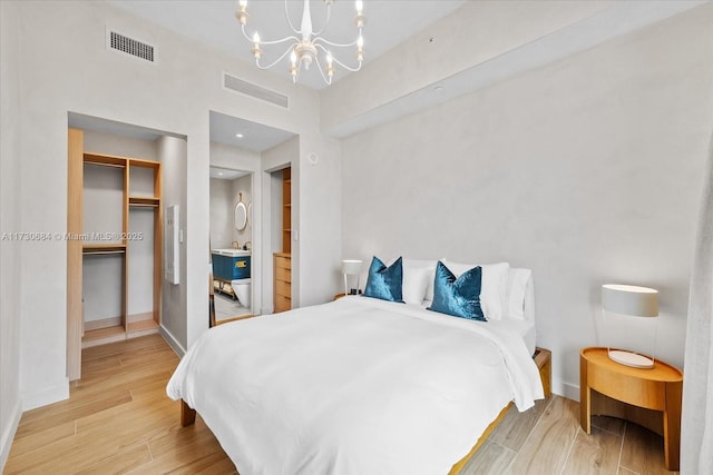 bedroom with a chandelier and a closet