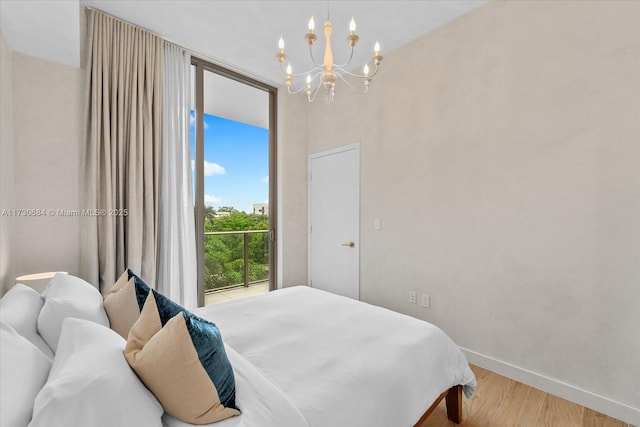 bedroom featuring light hardwood / wood-style flooring and an inviting chandelier