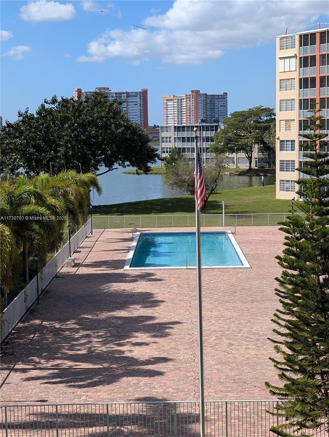 view of pool with a patio and a water view