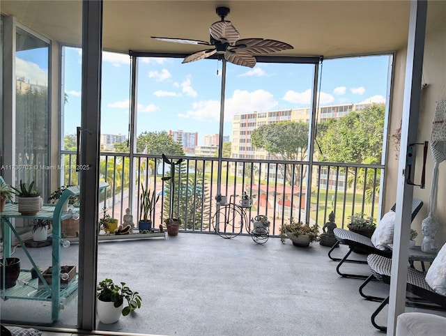 sunroom / solarium with a wealth of natural light and ceiling fan