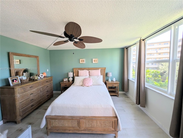 bedroom featuring ceiling fan and a textured ceiling