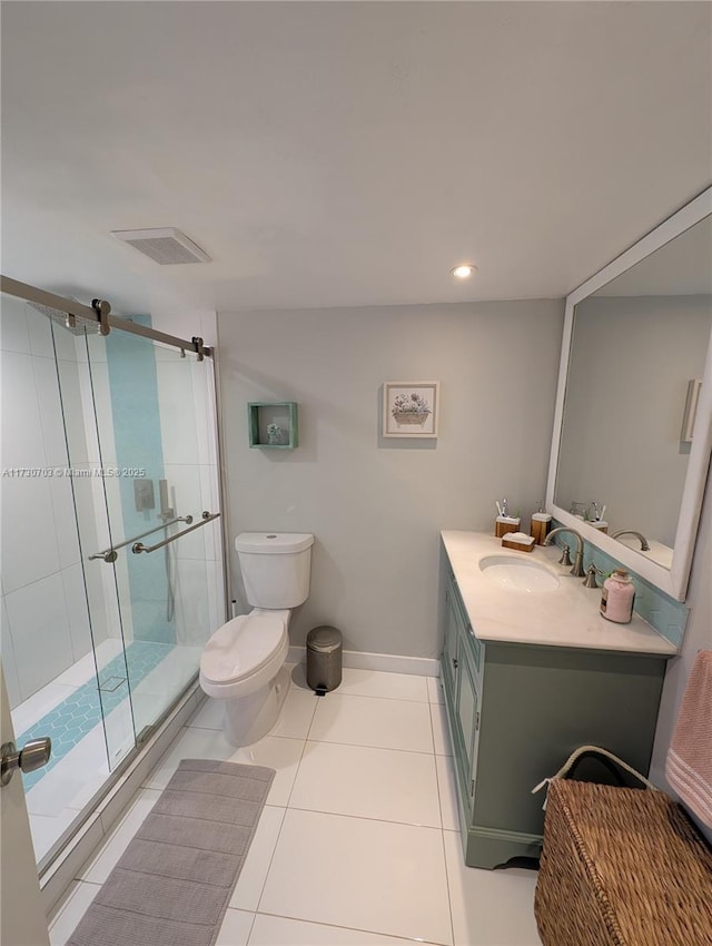 bathroom featuring tile patterned flooring, vanity, a shower with door, and toilet