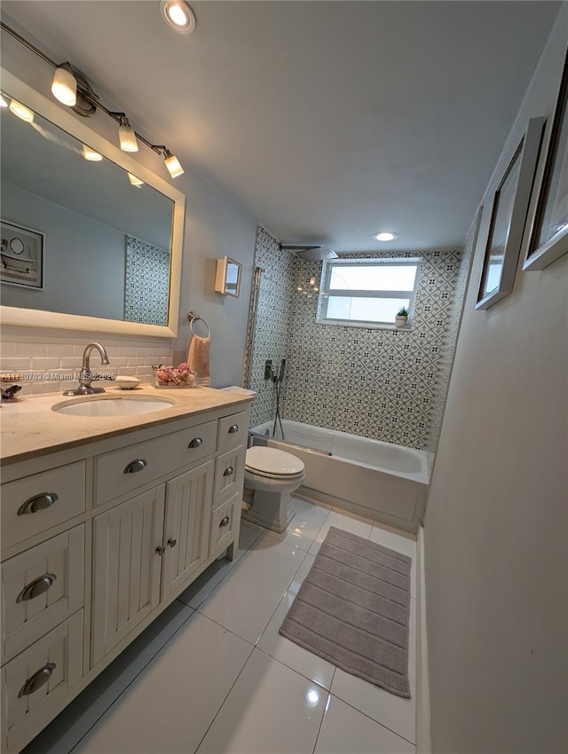 full bathroom with tiled shower / bath, backsplash, vanity, toilet, and tile patterned floors