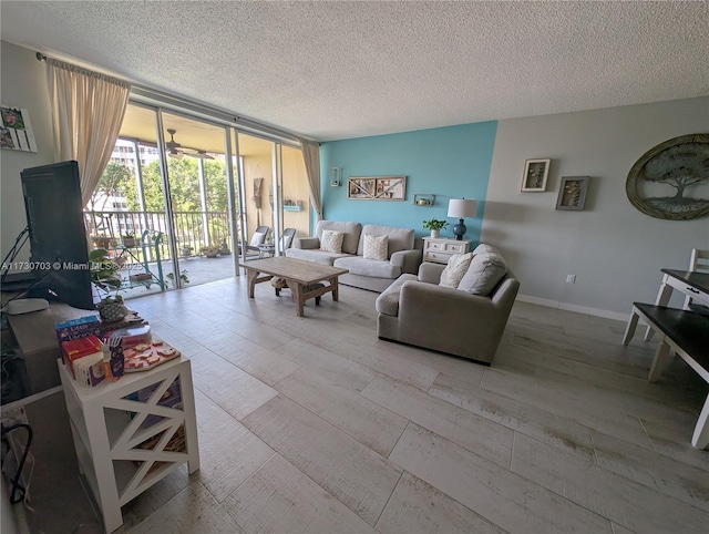 living room with floor to ceiling windows and a textured ceiling