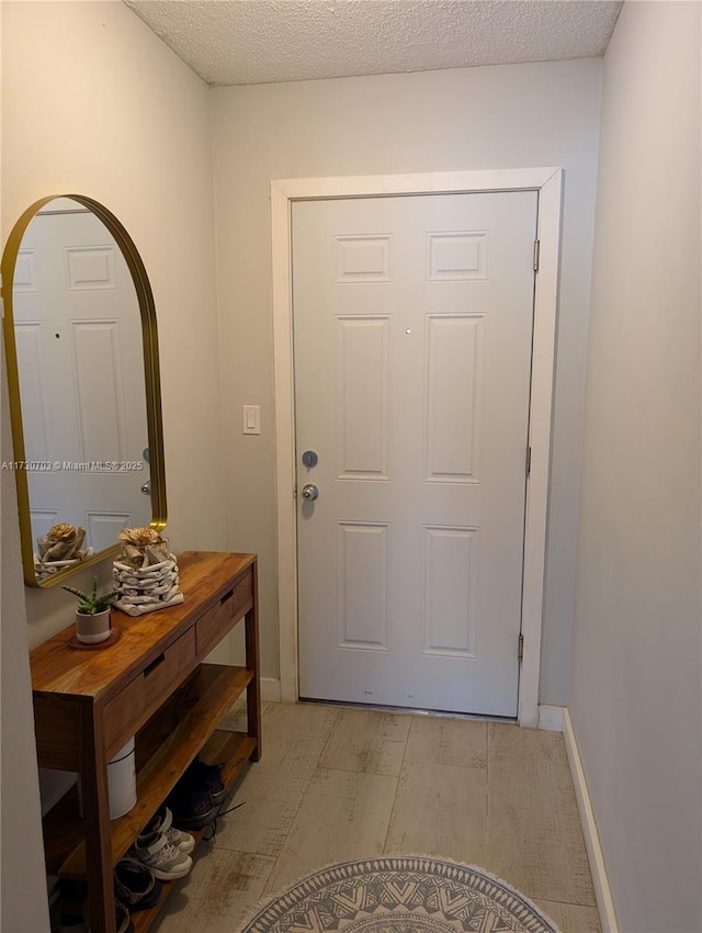 doorway featuring a textured ceiling