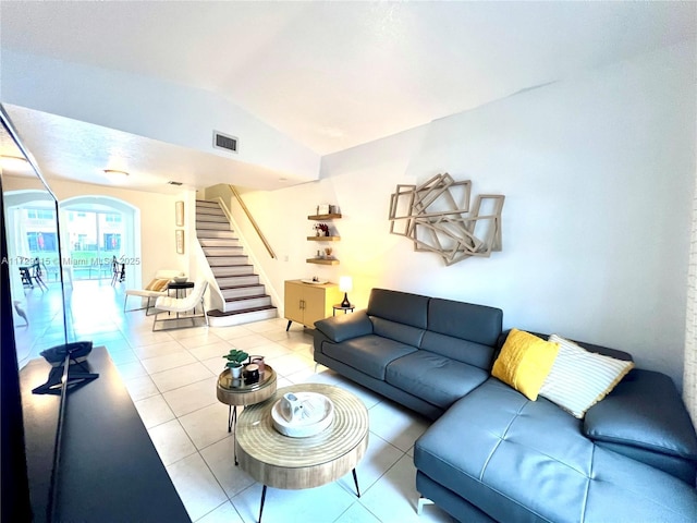 living room featuring light tile patterned floors and lofted ceiling