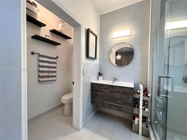 bathroom featuring vanity, toilet, a shower with door, and tile patterned flooring