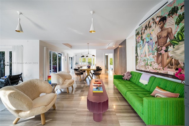 living room with a wealth of natural light and a raised ceiling