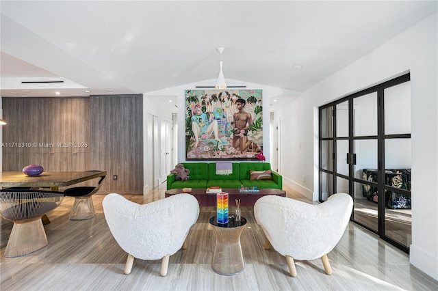 living room featuring light hardwood / wood-style floors and lofted ceiling