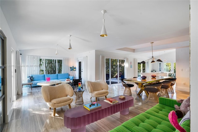 living room with light hardwood / wood-style flooring and lofted ceiling