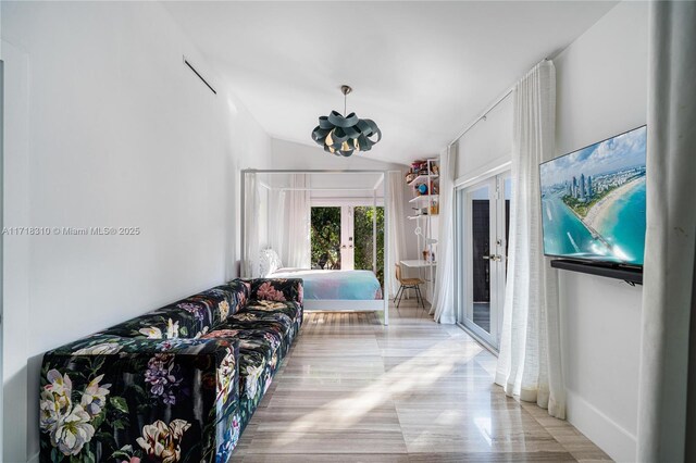 living room with lofted ceiling and french doors