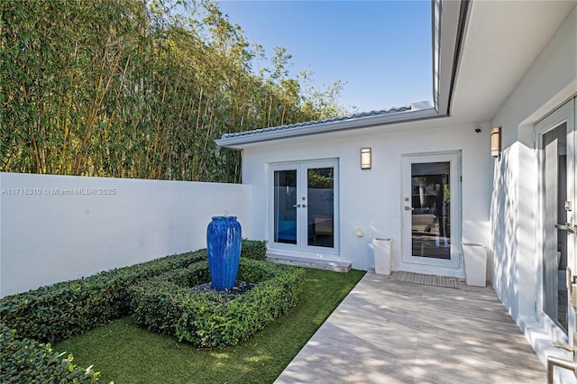 view of exterior entry featuring french doors