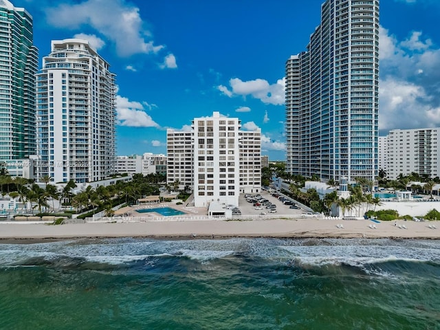 view of property featuring a water view and a view of the beach