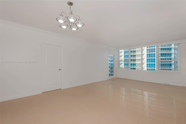 tiled spare room with crown molding and a chandelier