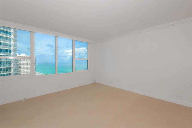 spare room featuring a water view and ornamental molding