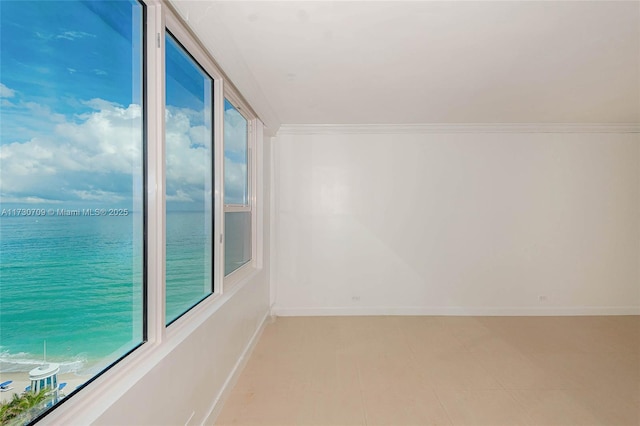 spare room featuring a water view and ornamental molding